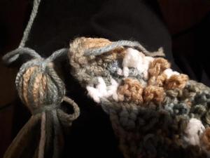 Thread tassel into textured scarf corner